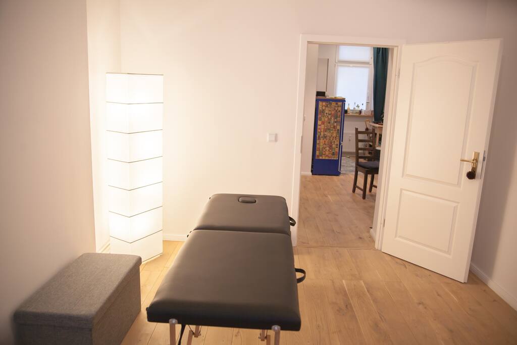 This is the living room view from the sofa perspective. You can see the kitchen in the background. The massage table can be folded. This is a great space for dancing Tango :-)