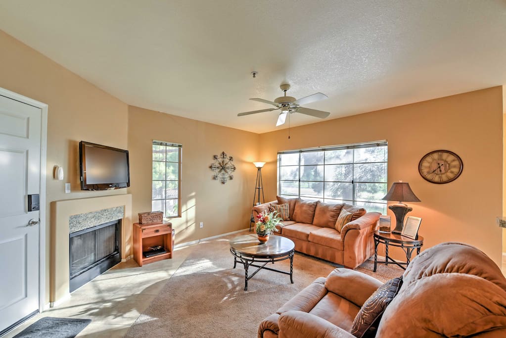 The spacious living room boasts comfy furniture and a gas fireplace.