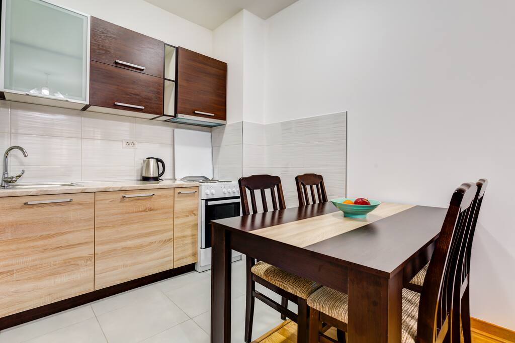 Dining room and kitchen are separated from living room. You can use a dining table with 4 chairs .