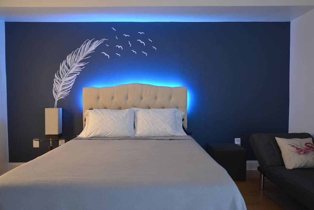 Large Bedroom with queen-size bed, chaise lounge, and custom lighting