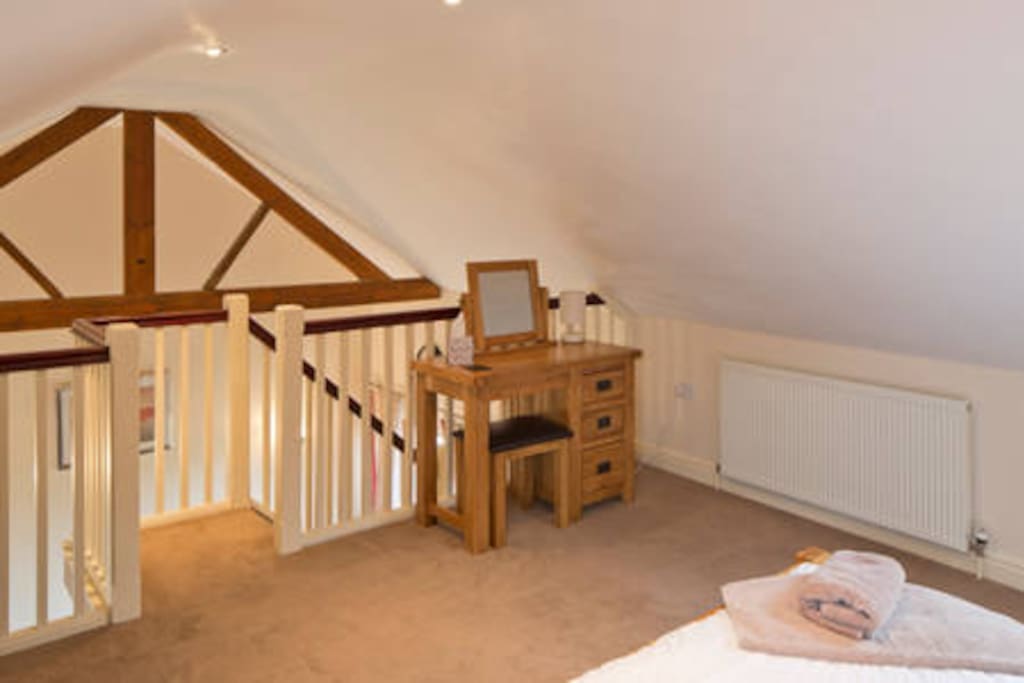 Upstairs open plan bedroom with king size bed
