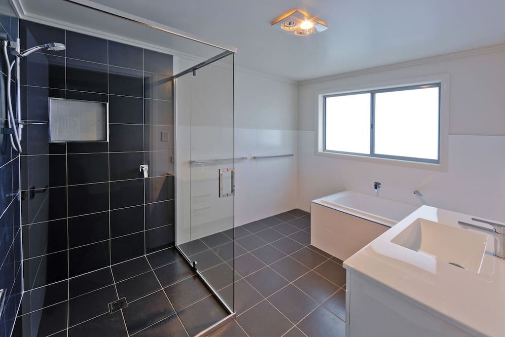 Large new bathroom all to yourself. An oversized shower and a relaxing bath awaits.