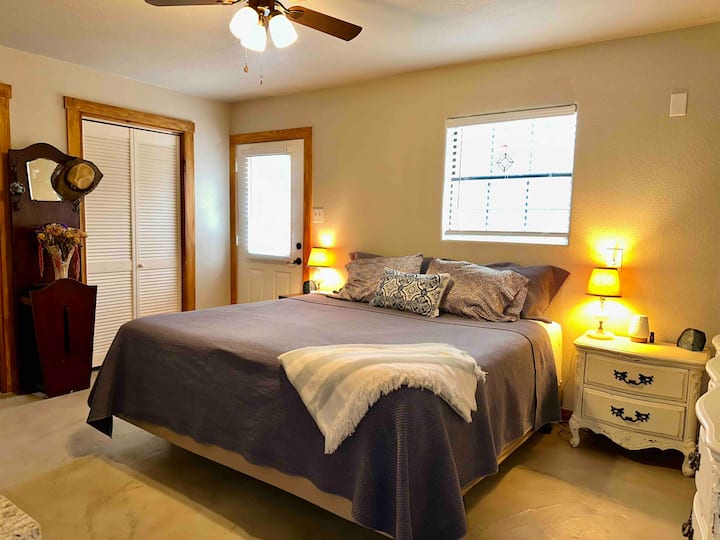 1 of 2 downstairs bedrooms has a classic/country vibe and a king bed. It has a TV w/ Roku (for signing into your streaming subscriptions), so you can hide away and enjoy a show. This room has a private entry/exit to the back of the property.