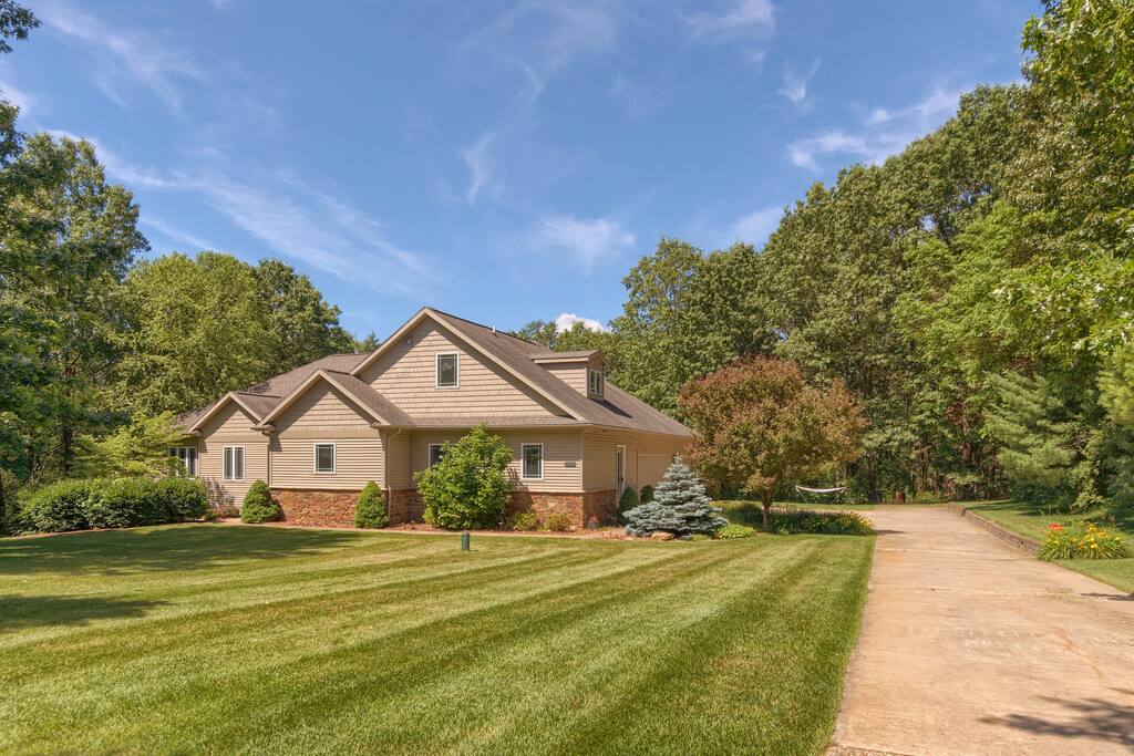 3-acre lot on a private street with only three homes. Large front lawn and trails through the woods in the back.