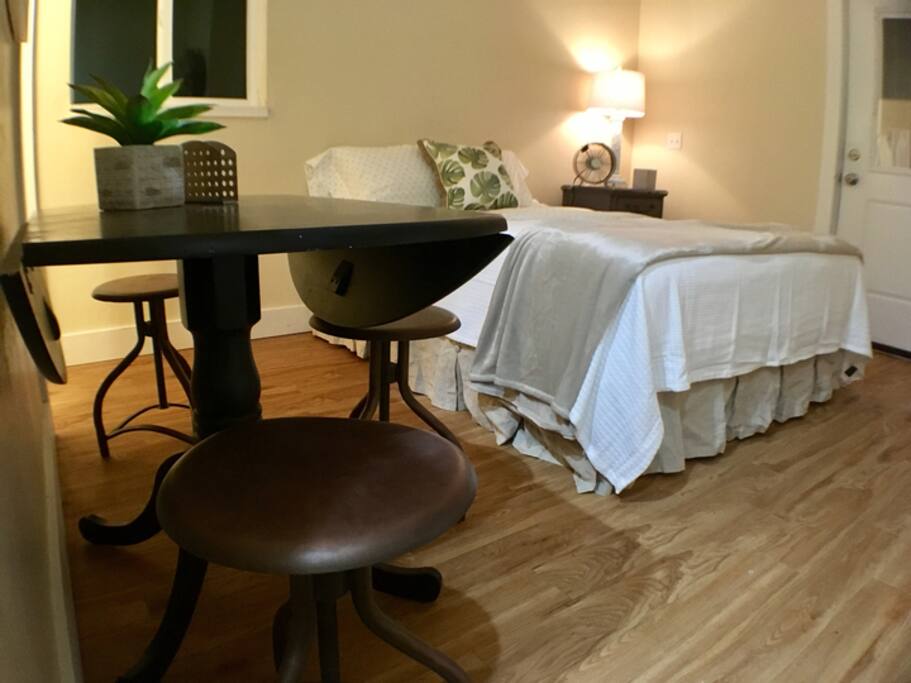 A view of the bed and dining nook.