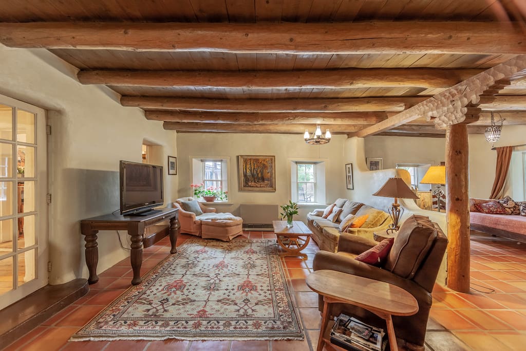 Comfortable goose down sofa and elegant persian rugs enhance the unique puebloan architecture.