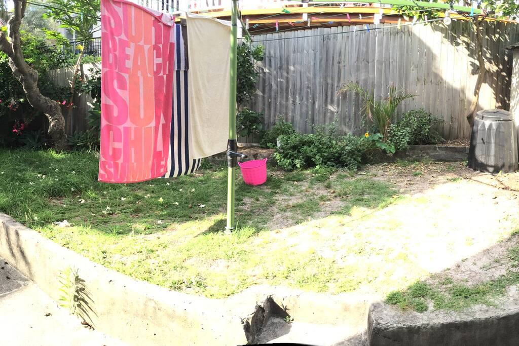 Terrace with BBQ, table, chairs and washing machine in a little room.