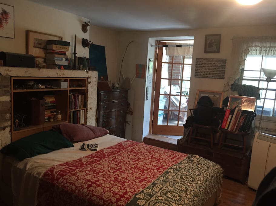 the garden bedroom is well lit and spacious. books and art surround you and make it easy to pass time enjoying the garden just steps beyond your door.