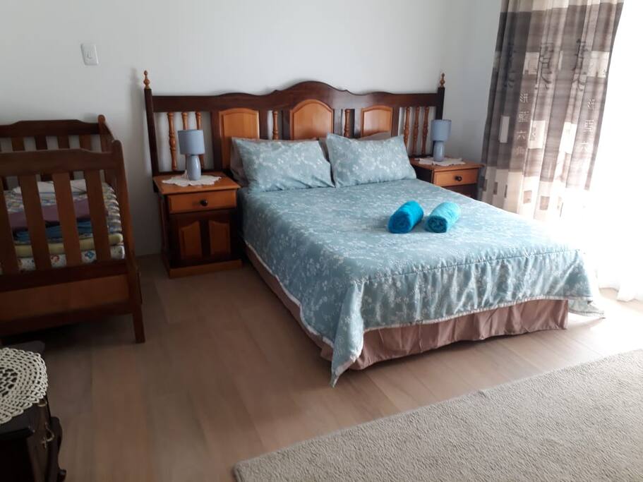 Main bedroom, includes shower and corner bath as well as a crib for a baby if needs be.