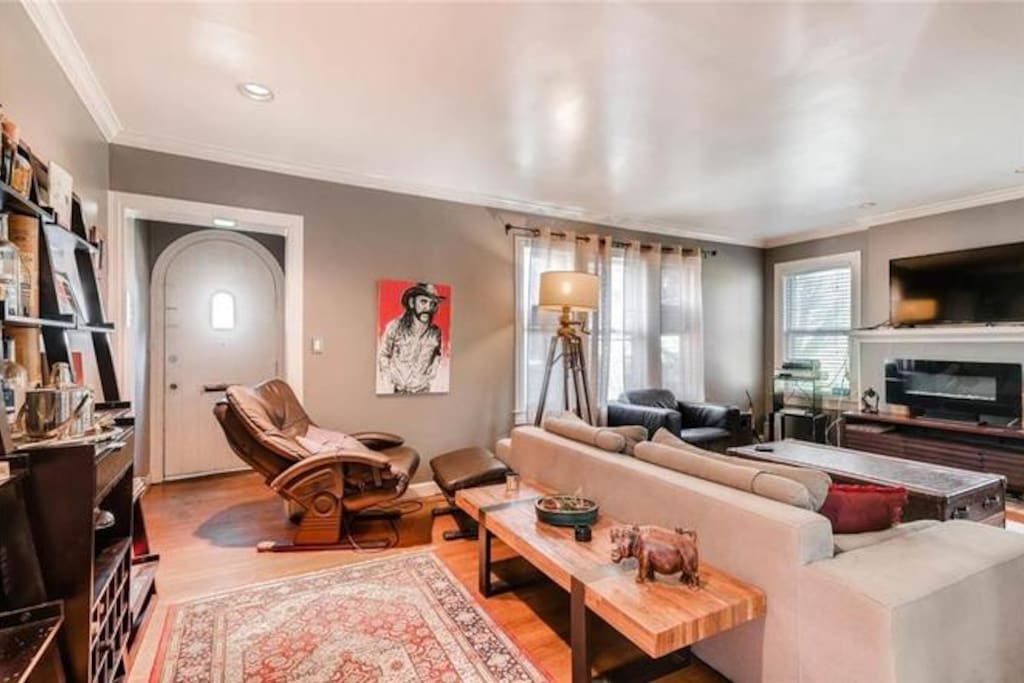 This is a big living room. TV with loaded Roku, great stereo with streaming, nice fake fireplace, seating for 6, a bar, some art, and so forth. Oh, and a massage chair.