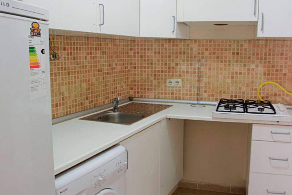 Kitchenette is equiped with fridge, oven, kettle and utensils.