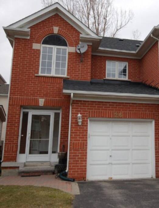 The front of the house, parking, driveway and main entrance.