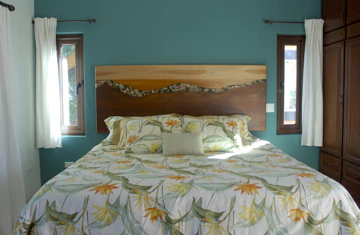 Artist designed headboard with shells, stones and beach glass.