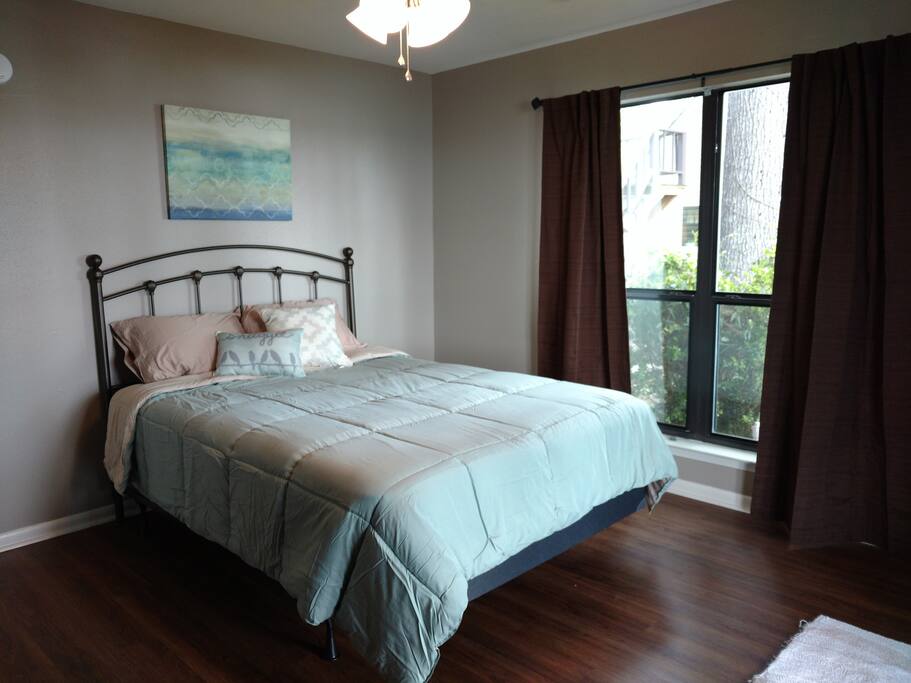 1st downstairs bedroom with queen bed a view of the lake!