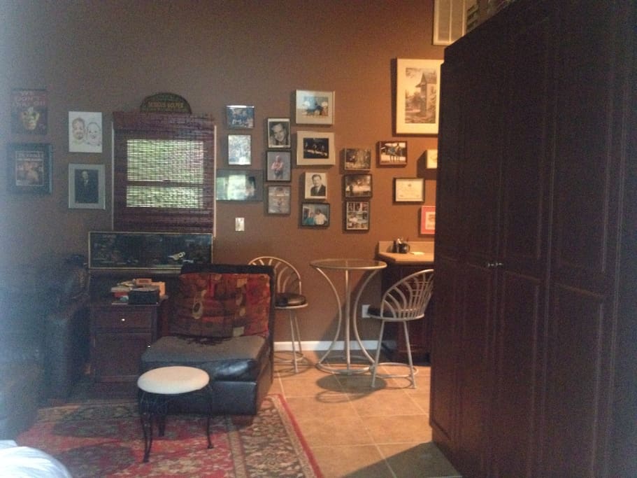 The studio has a Queen size Murphy bed that pulls down easily out of a Cherry cabinet. Two comfortable chairs with ottomans, a bistro set, and a large TV .