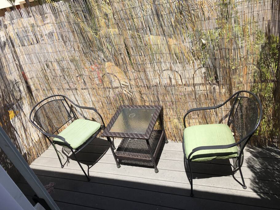 Outside patio with comfy outdoor chairs/table.