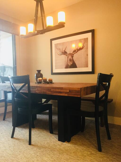 Spacious dining area, seat 8 comfortably around this table crafted from wood reclaimed from a ghost town and antique pine bench seat. Opens onto large outdoor patio with BBQ.