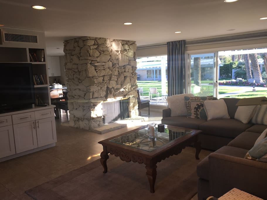 Living room with 56" large screen, cable television, overlooking patio and pool area.