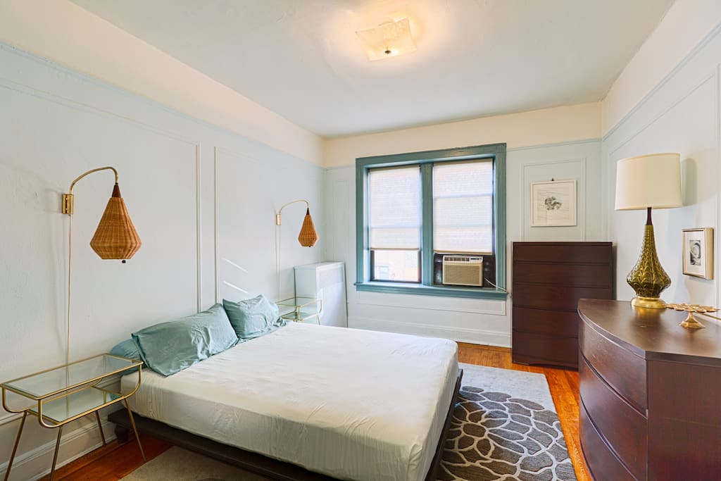 Bedroom - Queen size bed, vintage wall sconces, air conditioner and plenty of drawers. Vintage Vanity with large mirror not shown...on wall opposite window.