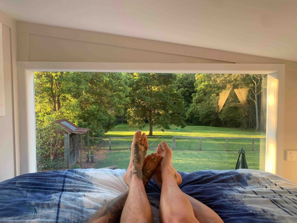 relaxing in th queen bedroom loft looking out the picture window 