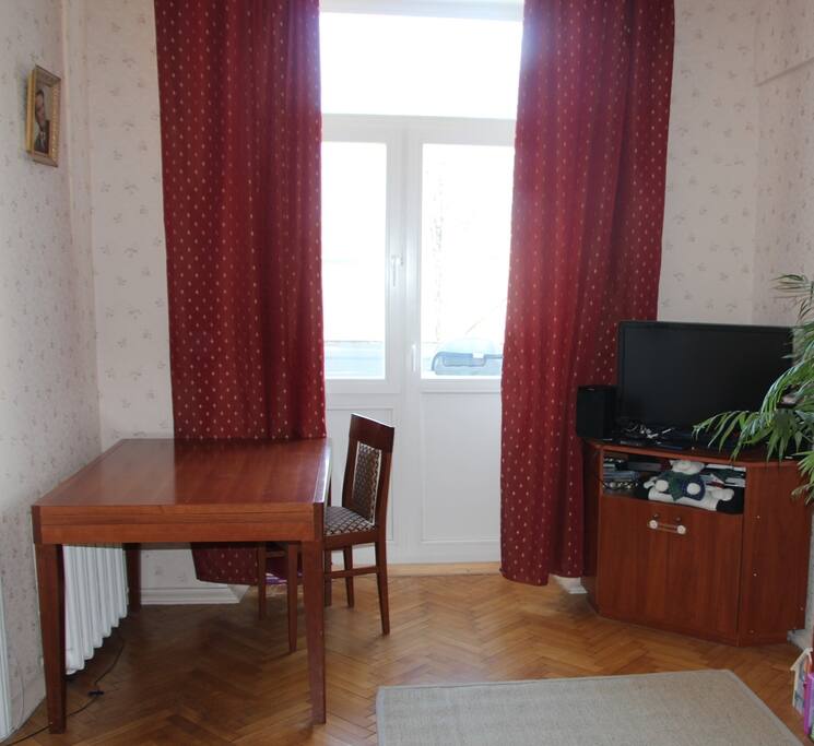 living room with a workplace, TV and a sofa