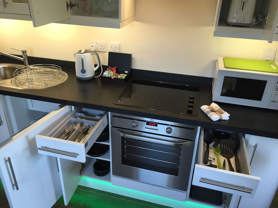 Well stocked kitchen full of accessories and complimentary tea and coffee, biscuits, milk and sugar.