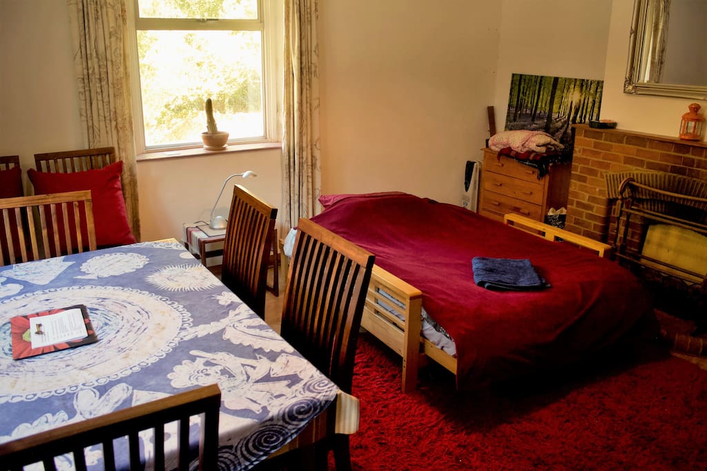 Spacious double room with futon bed and dining table. Room looks out onto an enclosed garden.
