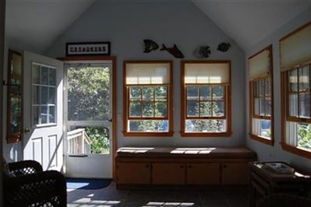 The screen porch off the kitchen, leads to parking area