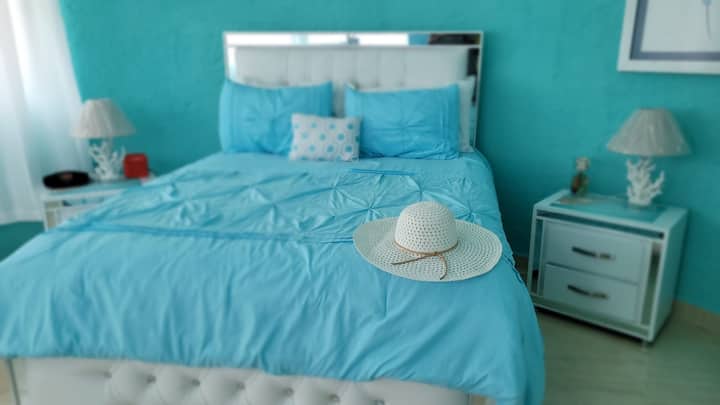 غرفة مشرقة جميلة بتصميم مرجاني هي سرير بحجم كبير.