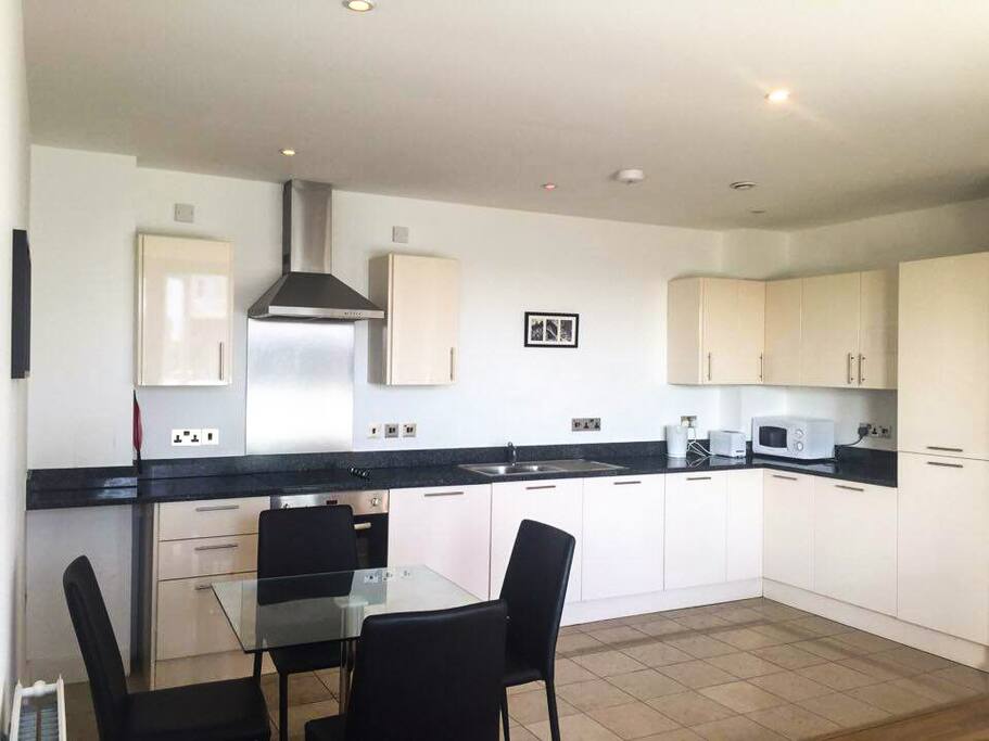 Open plan kitchen with a ceramic hob and granite worktops