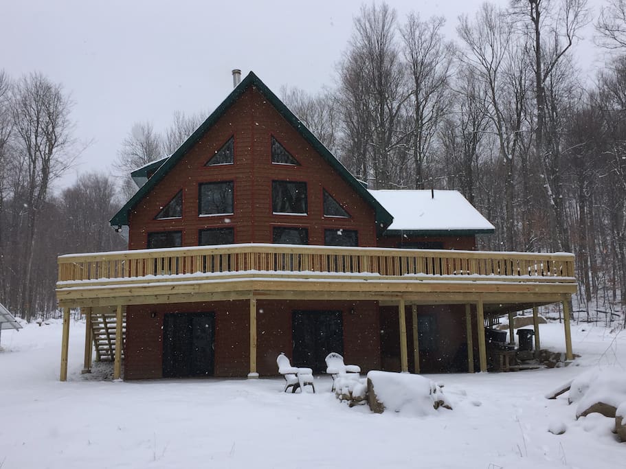 Mountain side of home with snow winter view