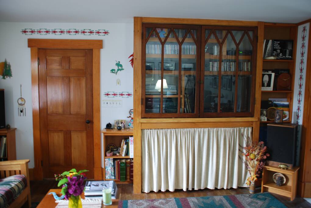 Living room with TV, stereo, photographs, and books to enjoy.