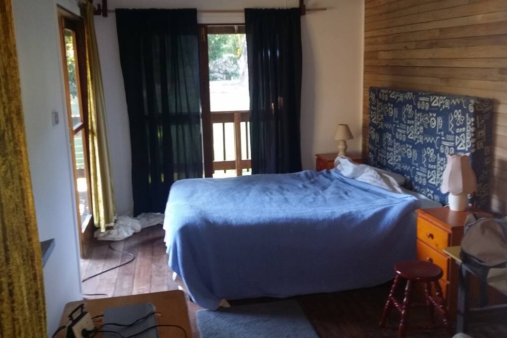bedroom opens up with 2 big ceder doors