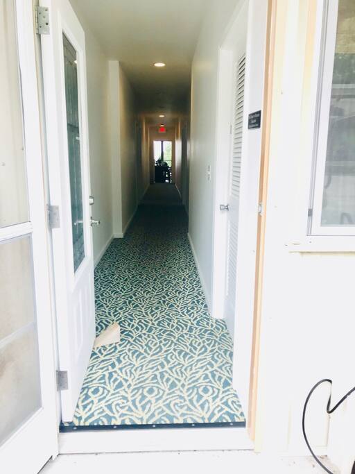 Entrance to rooms (#1-4 on the right, #5-8 on the left). Kitchen and dining area at the back.