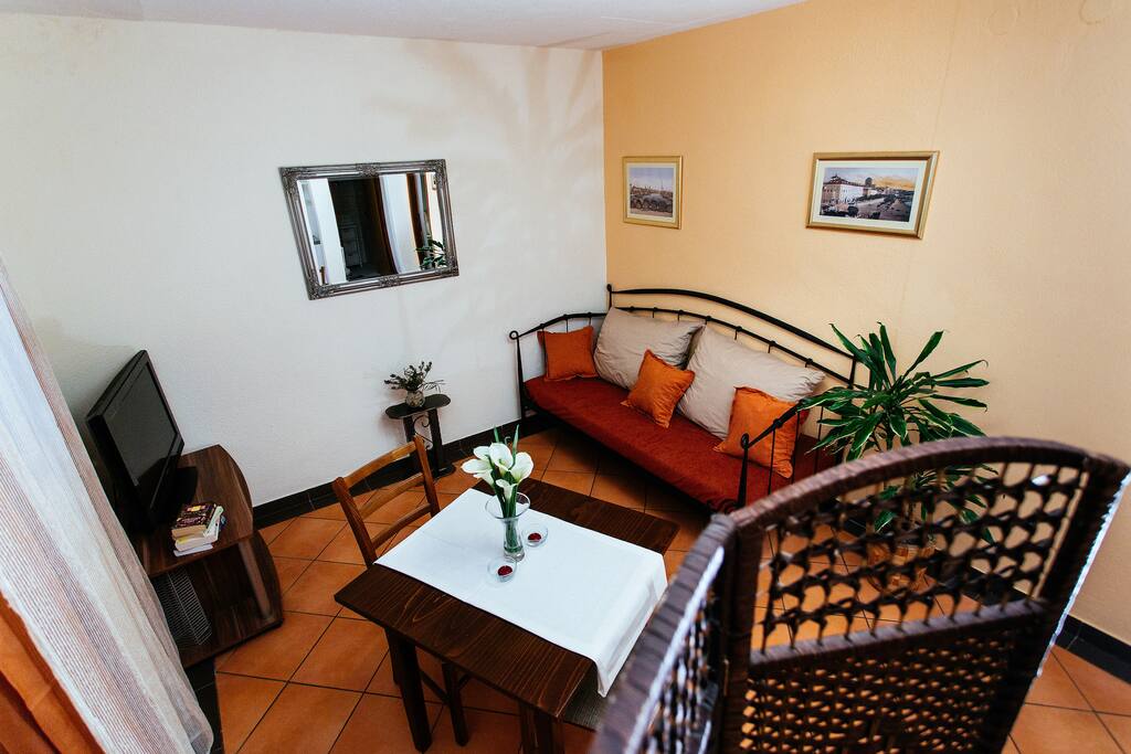 Dining area with a comfy sofa, a table and LCD Satellite Television
