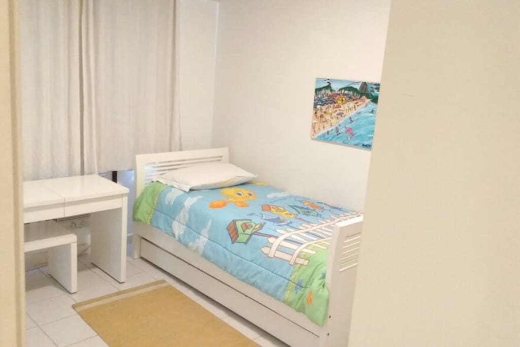 Guest bedroom with twin beds (one slides out from beneath the other).