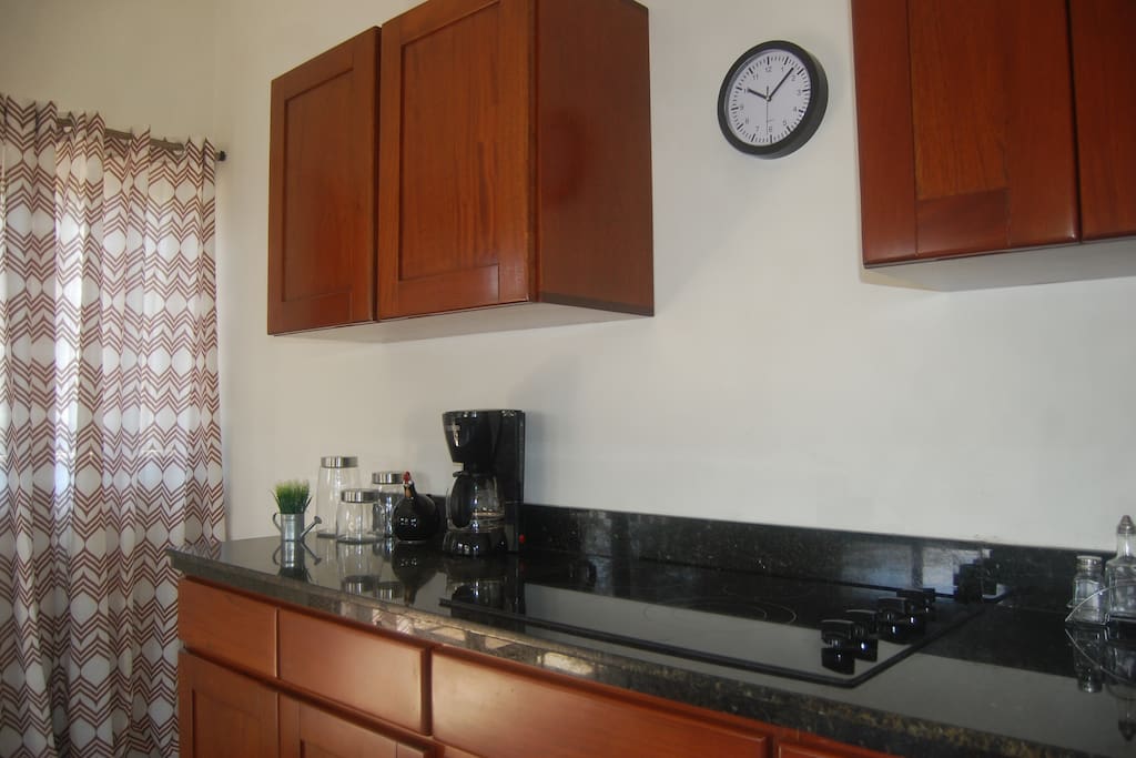 Kitchen with Coffemaker, Stove, Microwave and lot more.
