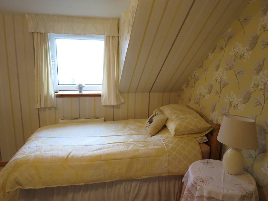 Single bed under the window in bedroom 1 with views of Loch Roag