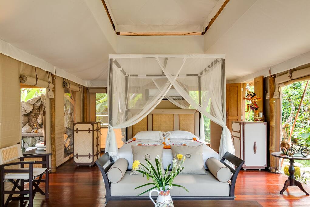 Interior of one tent showing safari furniture made from sustainably sourced teak wood.
