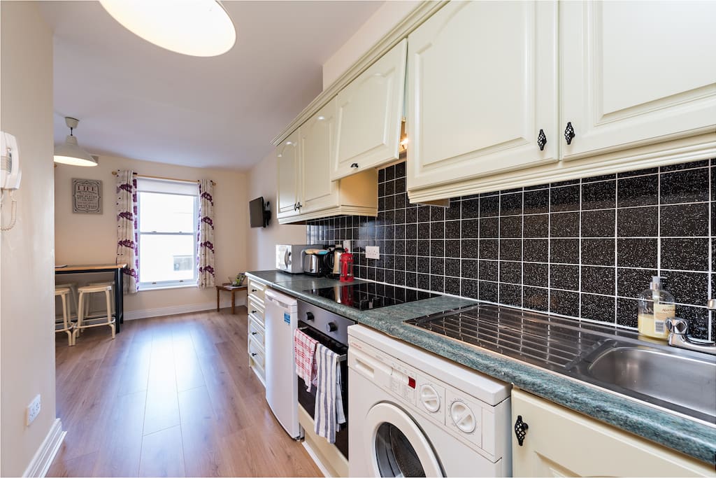 Open plan bright leaving room , wooden floors throughout apartment
