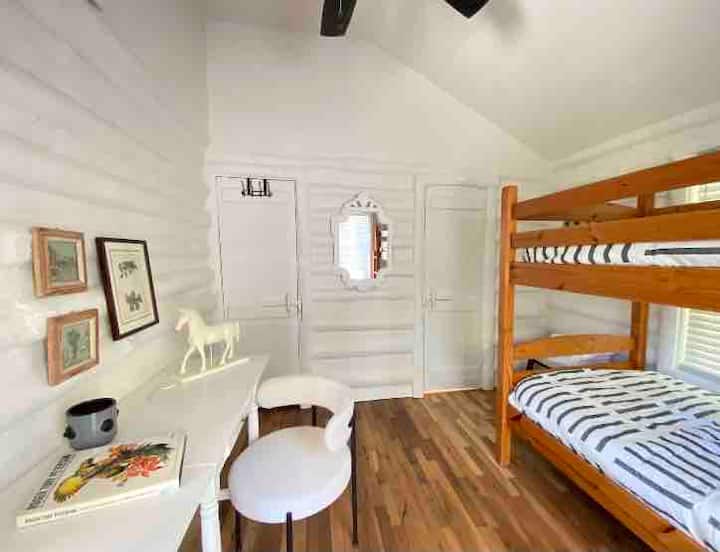 Bedroom 2: Twin bunkbeds. Doors go to small closet and the shared bathroom.  Desk is excellent for work and is already set up with an iPhone charger.