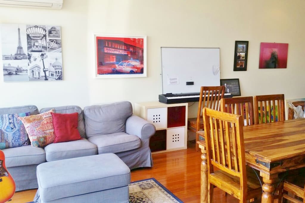 3 seater Couch, the apartment is full of artwork.