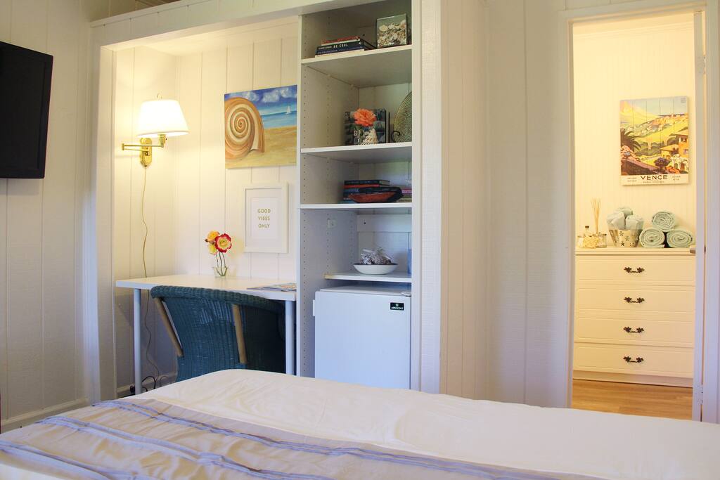 Bright and cozy main room with queen bed, desk for your laptop, TV. Entrance to bathroom.