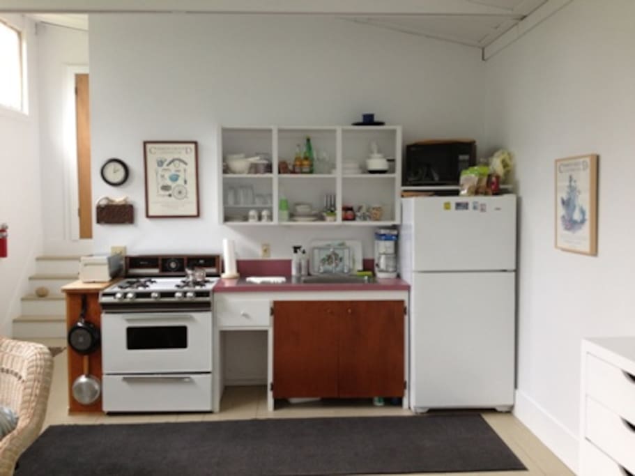 Kitchen with full size refrigerator & stove.