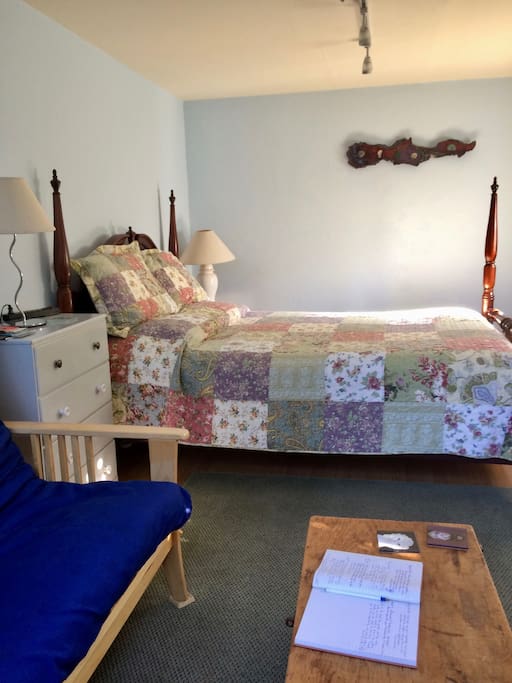 Comfortable queen size bed and a small couch make this room an inviting and cozy space