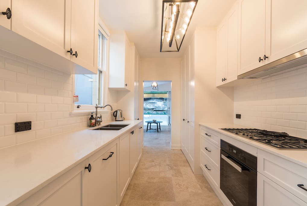 Beautiful kitchen with new appliances and stone floors