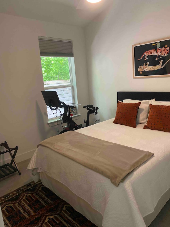 New purple queen size mattress and peloton in guest bedroom