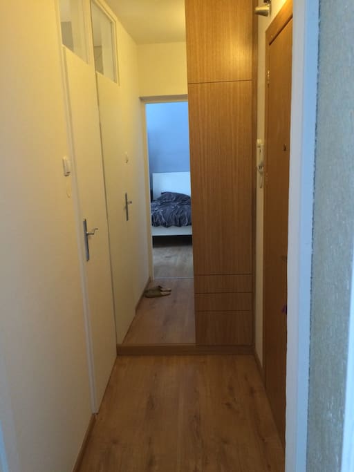 Bright doorway welcomes guest with pure, minimalistic lines that are noticable through whole concept of the flat