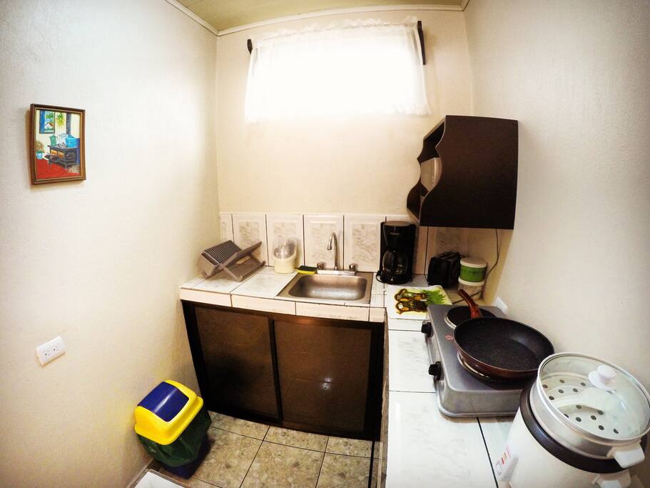 the kitchen has sugar, cooking oil, coffee, toothpicks, salt, forks, spoons, glasses, dishes