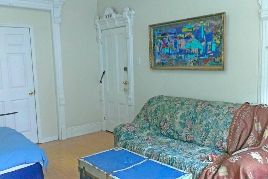 The bunk bed with the chest to eat and watch movies. The door you see in the corner is the one through which you access the rest of the apartement, the other door next to the bed is lock at all time and nobody uses it so its just like a wall.